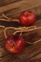 Red plum on wooden floor