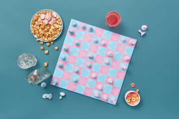 Chessboard with heart pattern and party snacks.