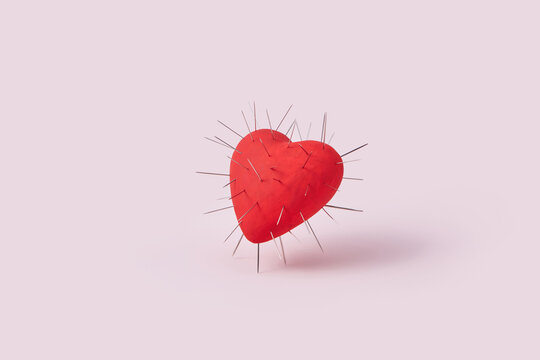 Red heart with spikes on pink background.