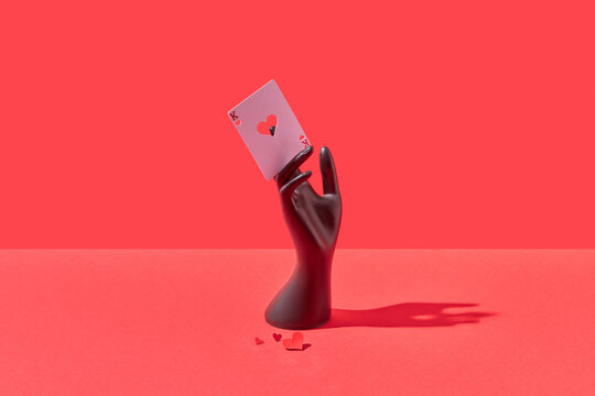 King of hearts card in black mannequin hand.