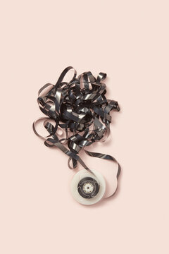 Messy black media tape with round reel.