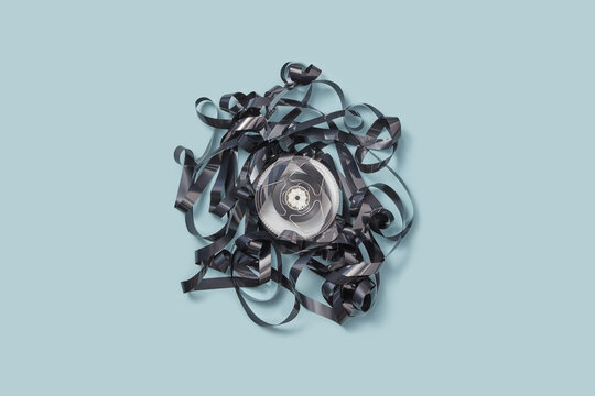 Black media tape around round reel.