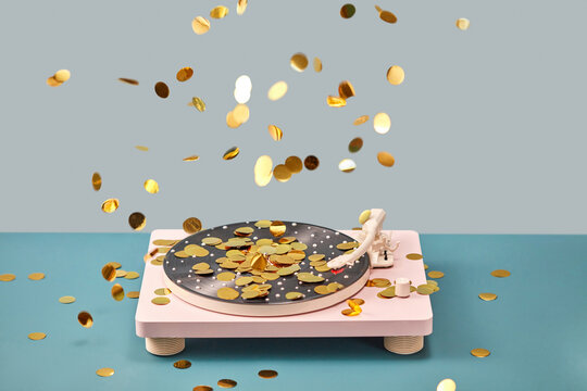 Pink vinyl player with golden confetti falling around.
