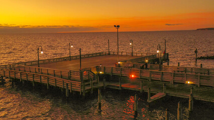 Fototapeta na wymiar Sunrise over the pier of the bay