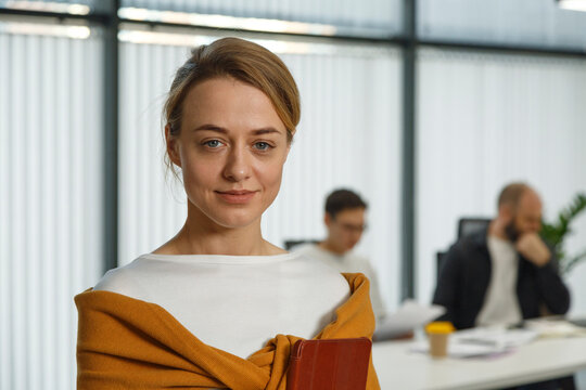 Female manager with tablet looking at camera in office
