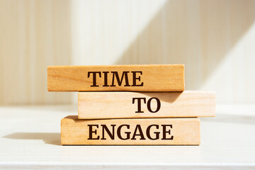 Wooden blocks with words 'Time to Engage'.