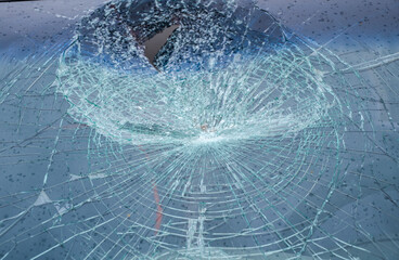 Close-up of broken glass texture or background of car windshield. Broken and damaged car