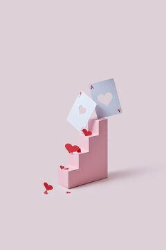 Paper steps with red hearts and playing cards.