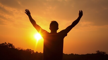 Fototapeta premium Silhouette of man raised hands at sunset background, close-up, in front of sun
