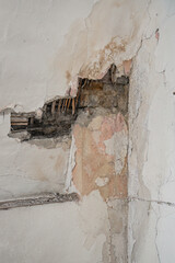 Damaged part of the plaster in the interior of the wall.
