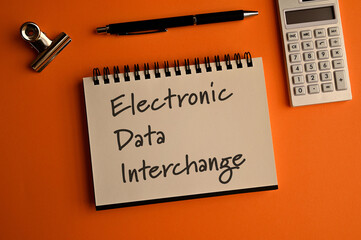 There is a notebook with the word Electronic Data Interchange. It is eye-catching image.
