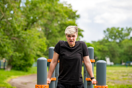 strong androgynous athlete working out outside