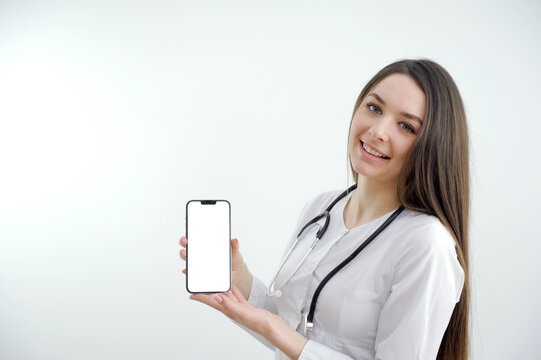 Portrait of experienced retired woman infection specialist use tablet search corona virus pneumonia vaccination wear white coat isolated over gray color background. High quality photo - Powered by Adobe