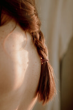 braid of a woman on a naked back