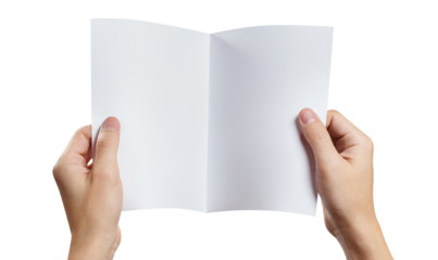 Hands holding a sheet of white paper with fold line in the middle, cut out