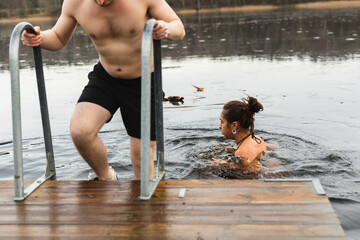 Friends having a cold bath in a lake