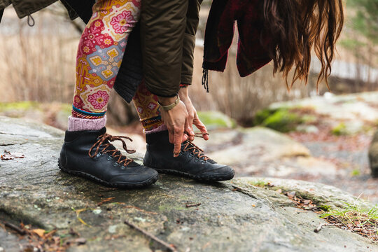 Close up of a unrecognizable person tying cordons in a hiking boots