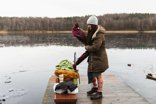 Woman getting ready for a swim in a lake
