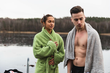 Friends having a breath after a cold swim in the lake