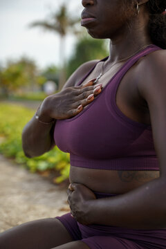 Woman doing breathing exercise in an outdoor setting