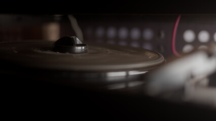 old vintage turntable is spinning without vinyl record. Retro player of broken radiolla.