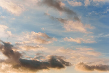 Fairy sunset sky with fluffy clouds. Sunset sky natural background. Dramatic Sky. Sunset In Yellow, Orange, Pink Colors. Feeling of dream or freedom. Copy space