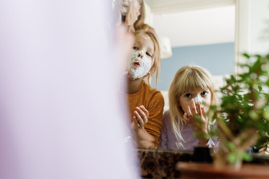 Three girl having fun with a shaving foam