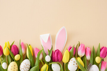 Easter idea. Top view photo of rabbit bunny ears pink yellow tulips flowers and colorful easter...