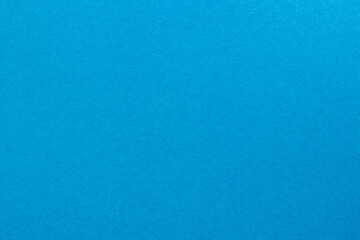 Fototapeta na wymiar Deep sky blue colored tinted paper texture swatch.