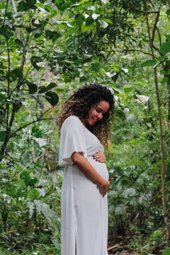 Pregnant woman surrounded by nature