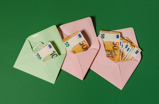 Money in a green and pink envelopes