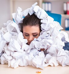 Businesswoman rejecting new ideas with lots of papers