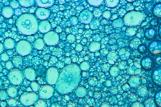 Aquamarine Color Oil And Soap Drops On Water Surface  
