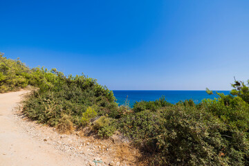 Beautiful view of mountain road overlooking Mediterranean sea of Rhodes island. Greece.