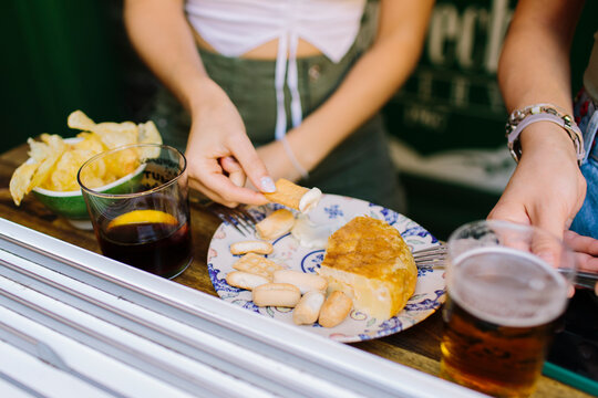 People having tapas at the counter of a bar