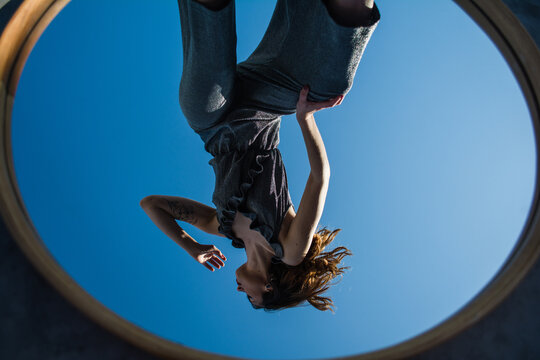 Woman upside down on mirror