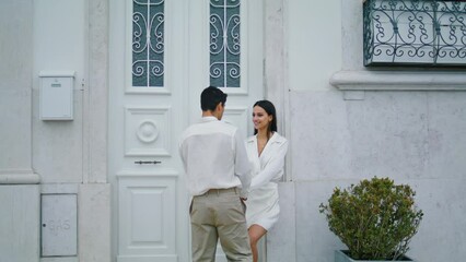 Coquettish lady dating man at urban place. Romantic lovely pair holding hands