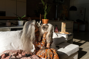 Mature woman with cat at home