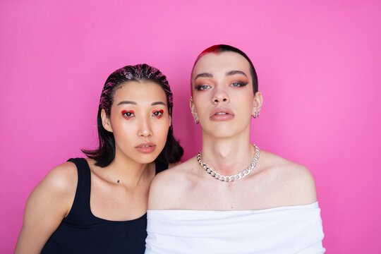 Eccentric Non-Binary Couple In Pink Background