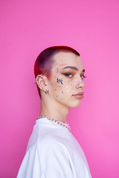 Young non binary gay with makeup in studio