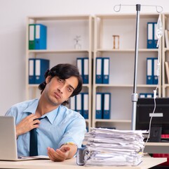 Young male employee in blood transfusion concept