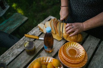 Woman cutting bread for a picnic