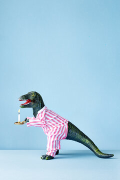 Tired dinosaur in pyjamas