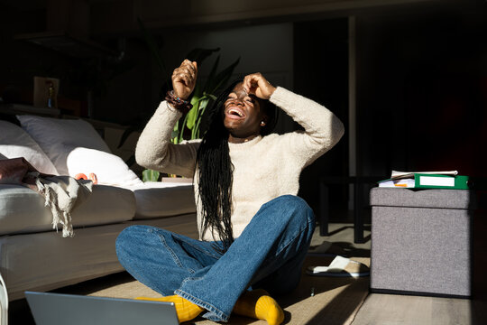 Teenager dancing using laptop