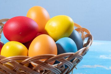 easter basket with straw and colored eggs