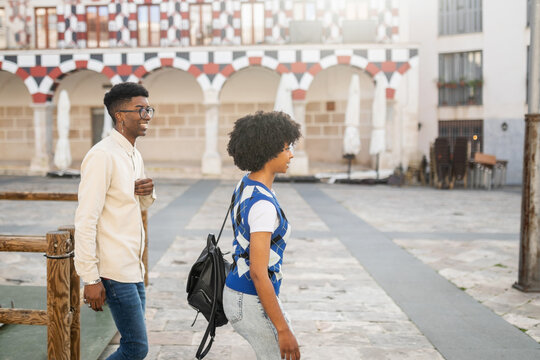 young black couple of friends walking in the city