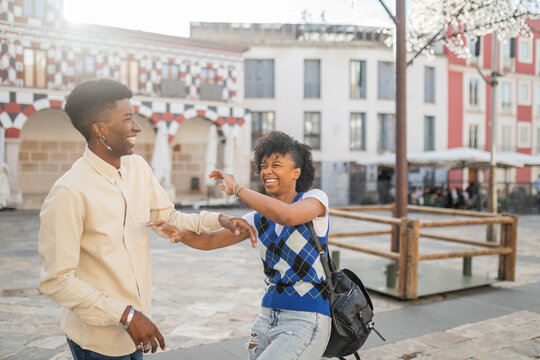 young black couple of friends walking in the city