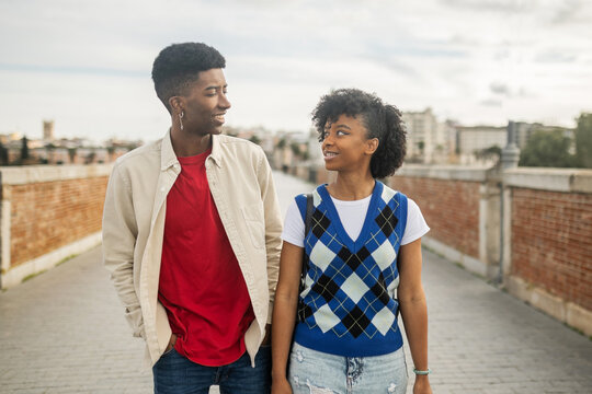 young black couple walking happily in the city