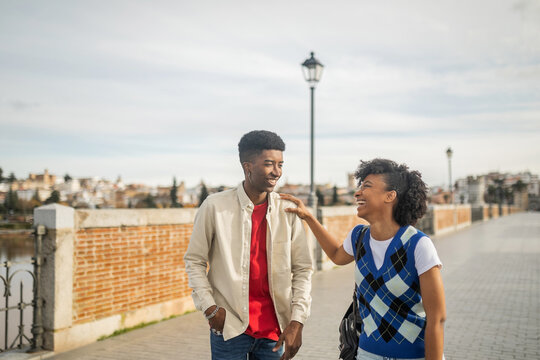 Young Black Couple Walking Happily In The City