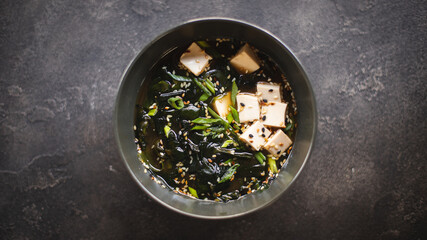 Asian food. Soup with seaweed, seafood and cheese in a stylish bowl. Restaurant service.